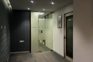 Modern interior corridor and glass-walled cabins at Dimension SAP Training facility.